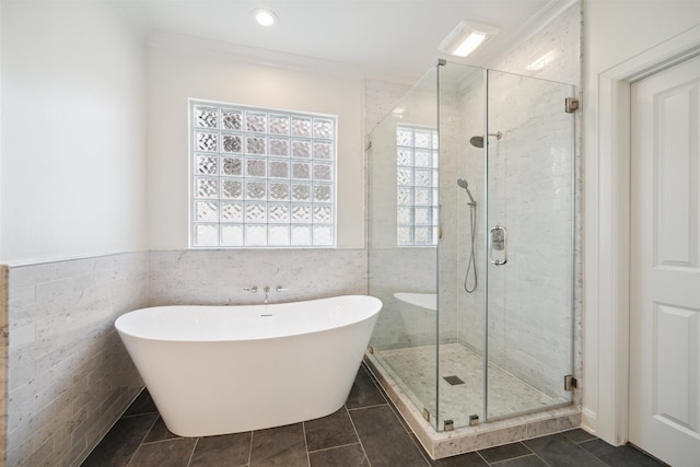 bathroom with plus walk in shower, tile walls, and ornamental molding