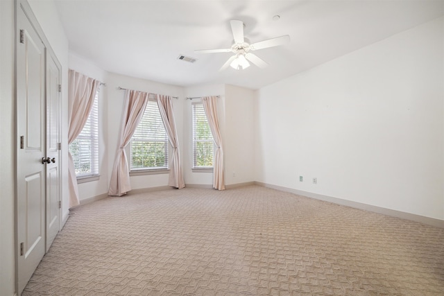 carpeted empty room featuring ceiling fan