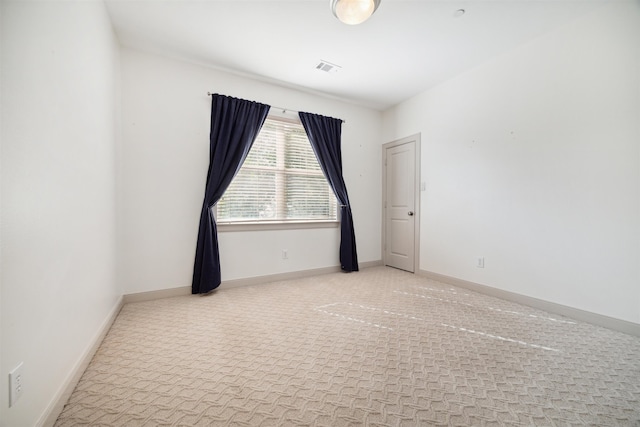 unfurnished room with light carpet