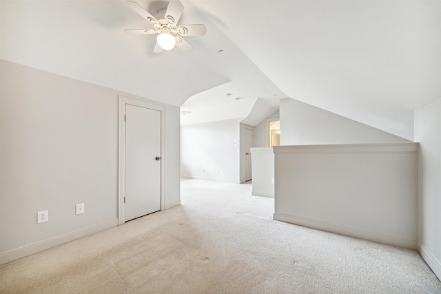 additional living space featuring ceiling fan, light colored carpet, and lofted ceiling