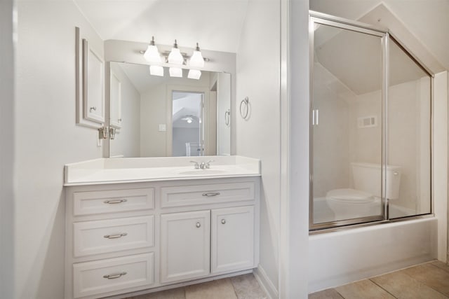 bathroom featuring shower / bath combination with glass door, tile patterned floors, vanity, and lofted ceiling