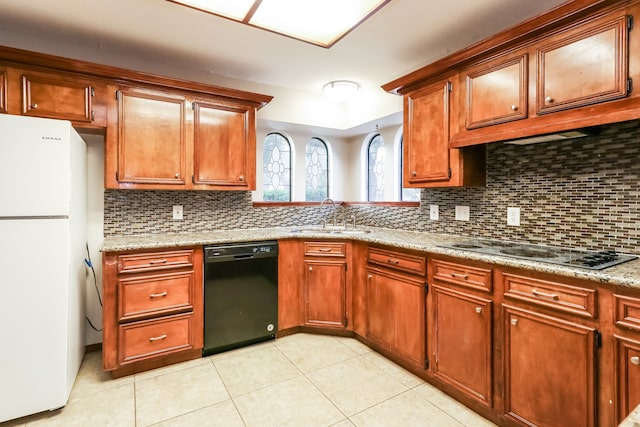 kitchen with decorative backsplash, cooktop, sink, black dishwasher, and white fridge