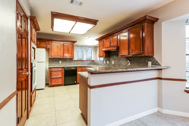 kitchen with kitchen peninsula, light stone countertops, white appliances, and decorative backsplash