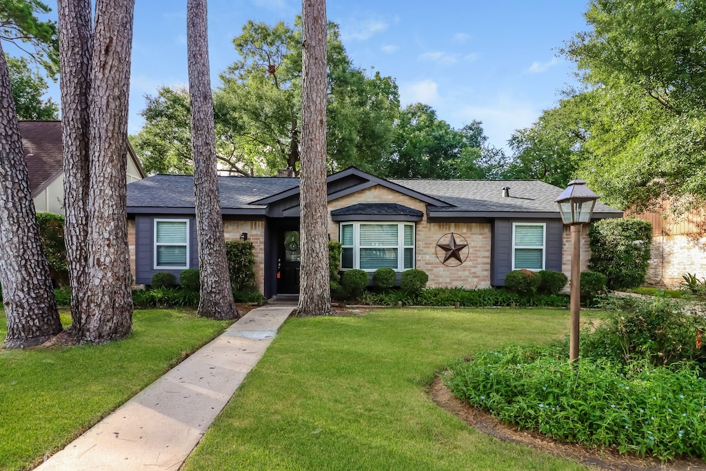 ranch-style house with a front lawn