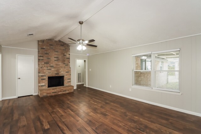 unfurnished living room featuring vaulted ceiling with beams, dark hardwood / wood-style floors, a brick fireplace, and ceiling fan