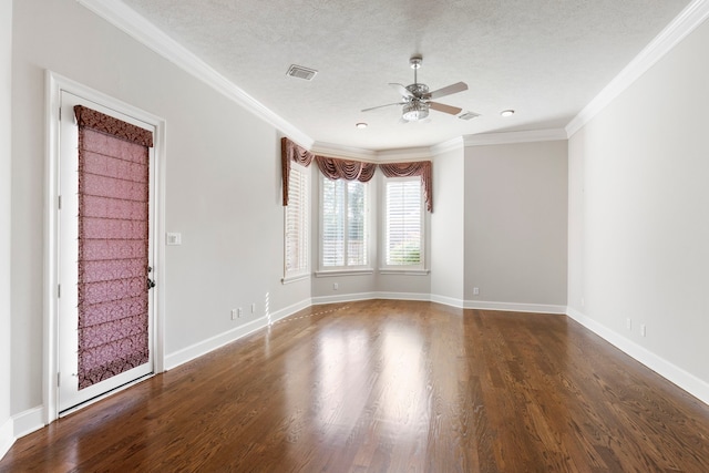 spare room featuring dark hardwood / wood-style floors, ceiling fan, ornamental molding, and a textured ceiling