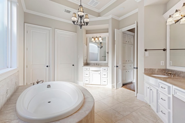 bathroom with tile patterned flooring, a relaxing tiled tub, a chandelier, vanity, and ornamental molding