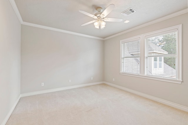 spare room with ceiling fan, light colored carpet, and ornamental molding