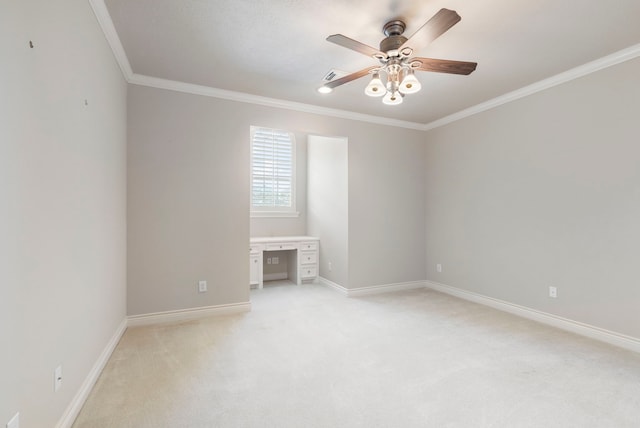 carpeted spare room featuring ceiling fan and ornamental molding