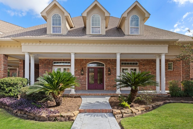 view of front of property featuring french doors and covered porch