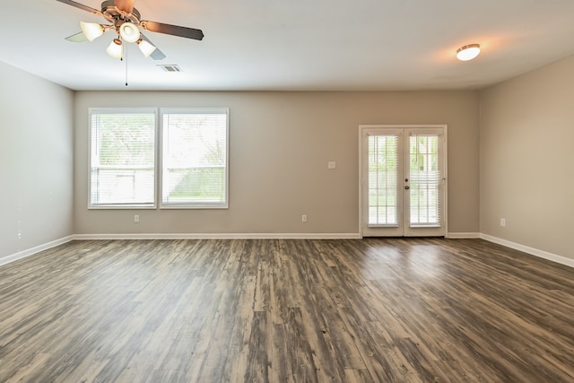 spare room featuring french doors, plenty of natural light, dark wood-type flooring, and ceiling fan