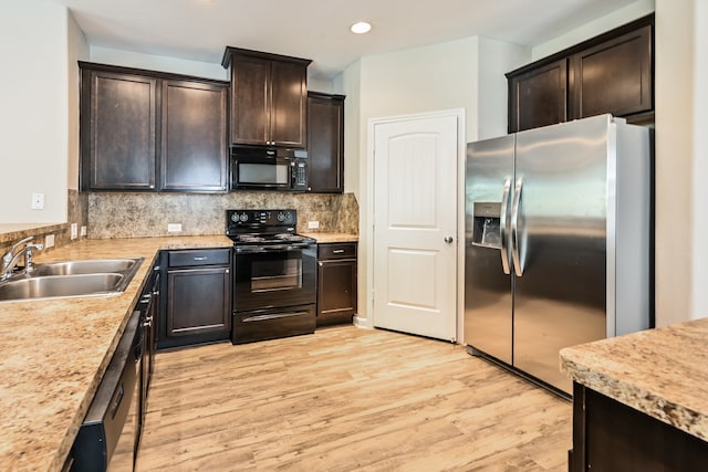 kitchen with black appliances, sink, tasteful backsplash, dark brown cabinets, and light hardwood / wood-style floors