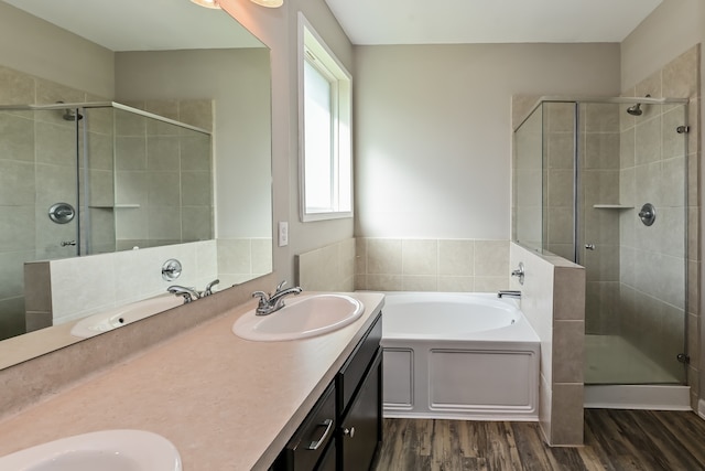 bathroom with vanity, independent shower and bath, and hardwood / wood-style flooring