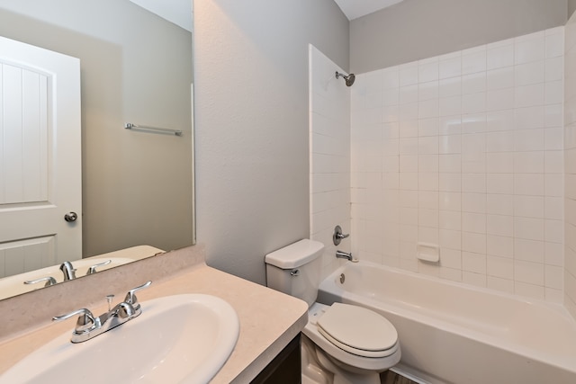 full bathroom with tiled shower / bath combo, toilet, and vanity