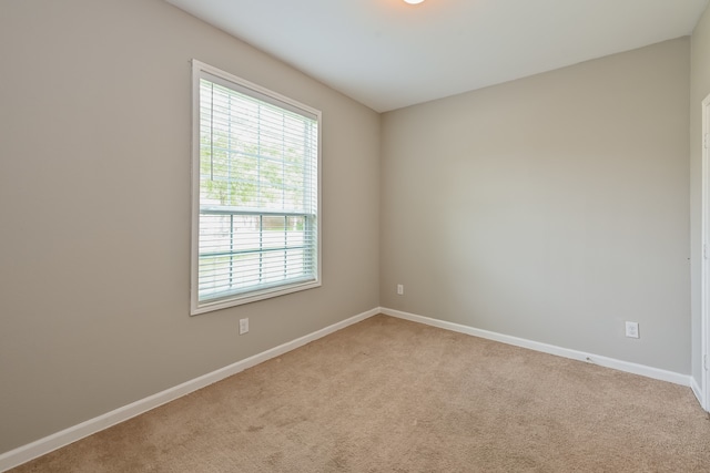 unfurnished room featuring light colored carpet