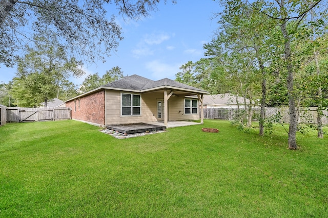 rear view of property featuring a patio and a lawn