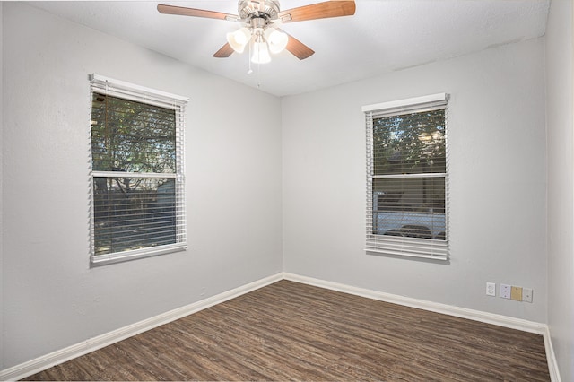 spare room with ceiling fan and dark wood-type flooring