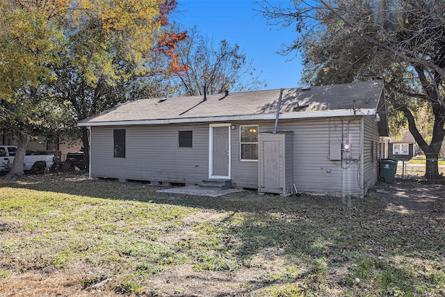 rear view of house with a lawn