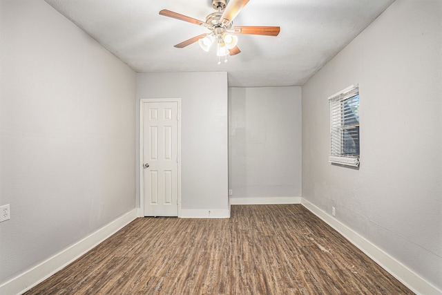 spare room featuring ceiling fan and dark hardwood / wood-style floors