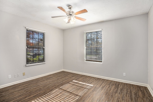 empty room featuring a textured ceiling, dark hardwood / wood-style flooring, and ceiling fan