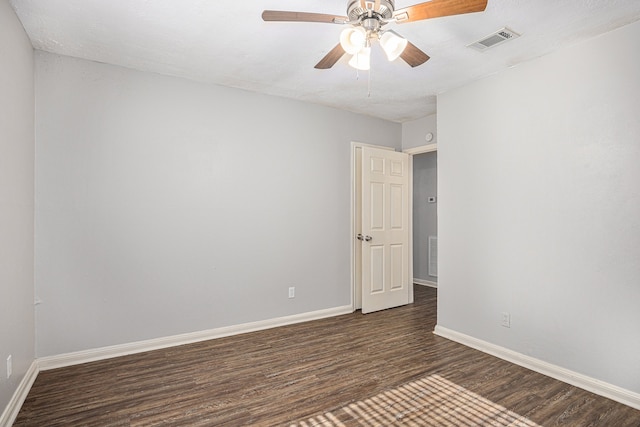 spare room featuring ceiling fan and dark wood-type flooring