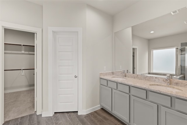 bathroom with hardwood / wood-style floors and vanity