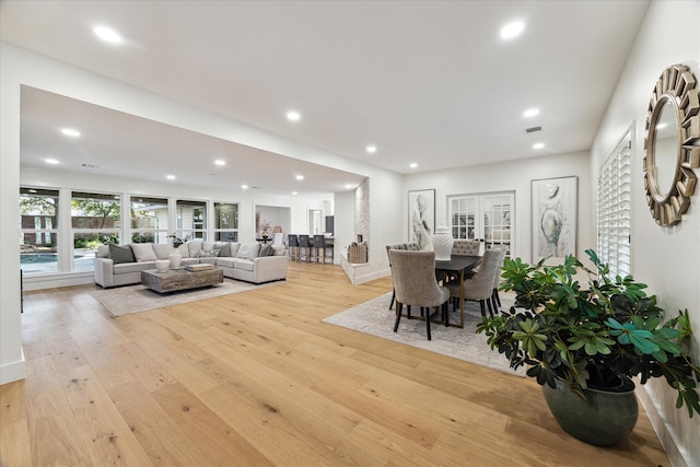 living room featuring light hardwood / wood-style flooring and french doors