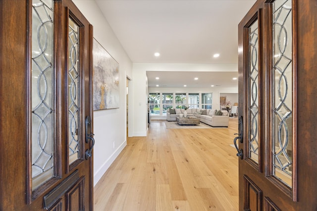 foyer entrance with light hardwood / wood-style floors