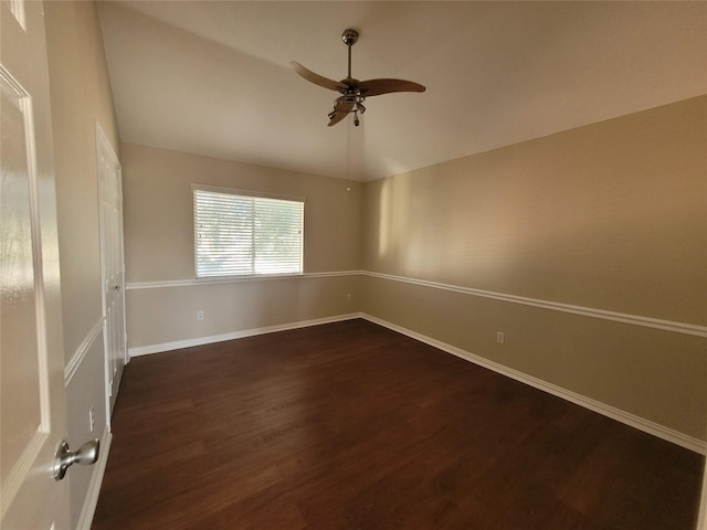 spare room featuring ceiling fan, dark hardwood / wood-style flooring, and lofted ceiling