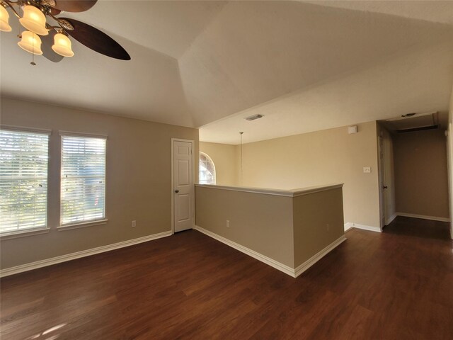 spare room with ceiling fan, lofted ceiling, and dark wood-type flooring