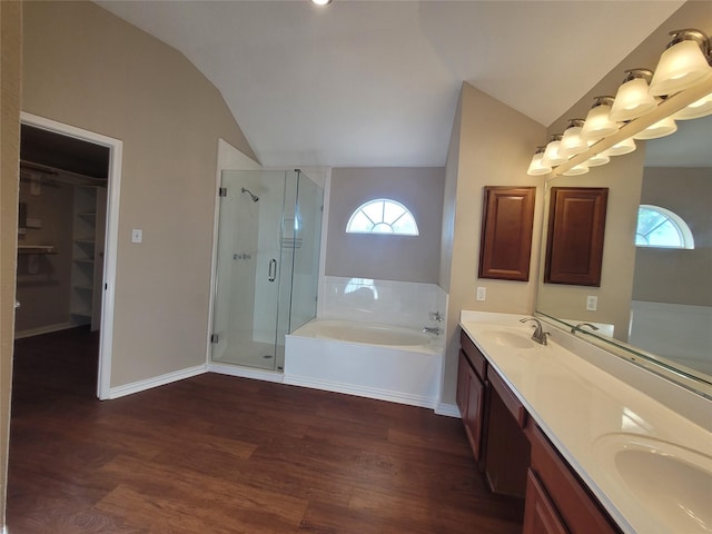 bathroom featuring vanity, separate shower and tub, wood-type flooring, and vaulted ceiling