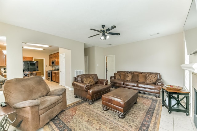 living room with light tile patterned floors and ceiling fan