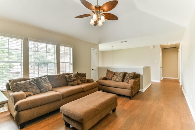 living room featuring ceiling fan, light wood-type flooring, and lofted ceiling