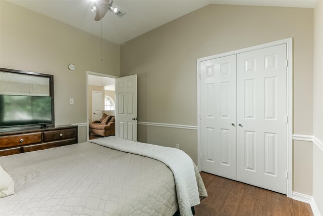 bedroom with ceiling fan, wood-type flooring, lofted ceiling, and a closet