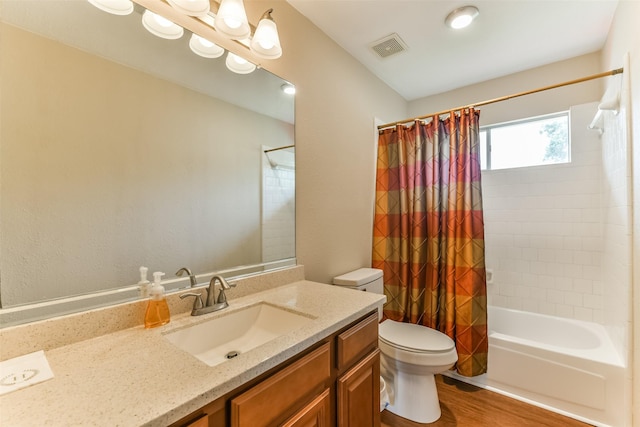 full bathroom with hardwood / wood-style floors, vanity, toilet, and shower / bathtub combination with curtain