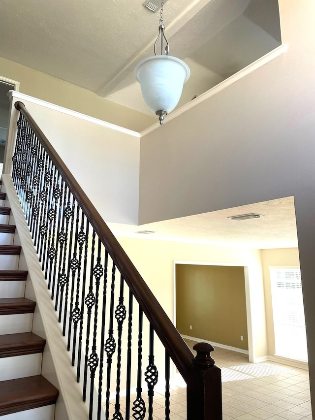 staircase with tile patterned floors