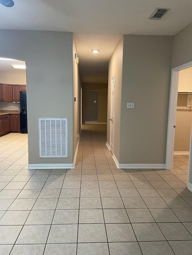 hallway featuring light tile patterned flooring