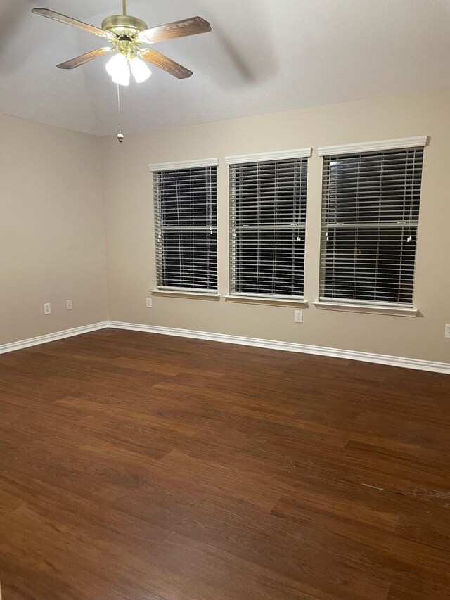 empty room featuring ceiling fan and dark hardwood / wood-style flooring