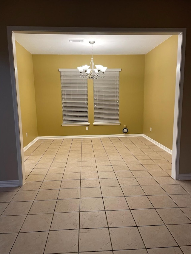 unfurnished dining area with light tile patterned floors and a chandelier