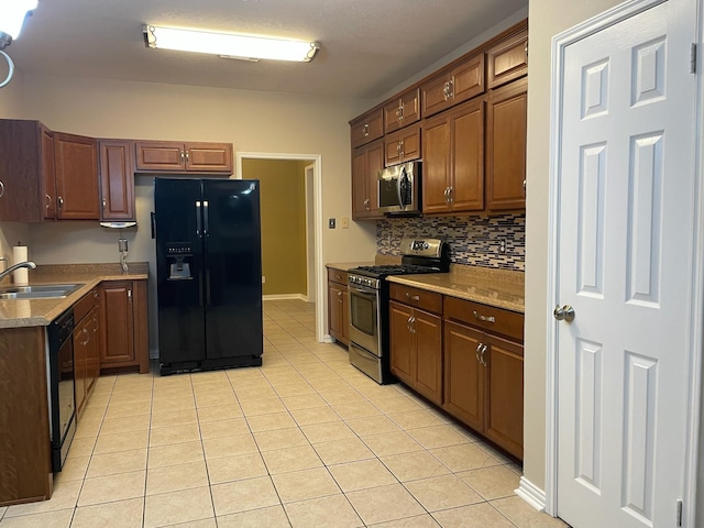 kitchen with black appliances, backsplash, light tile patterned flooring, and sink