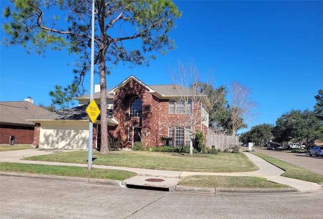 view of front of property featuring a garage and a front lawn