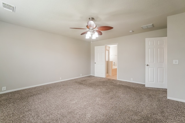 empty room with carpet flooring, ceiling fan, and a textured ceiling