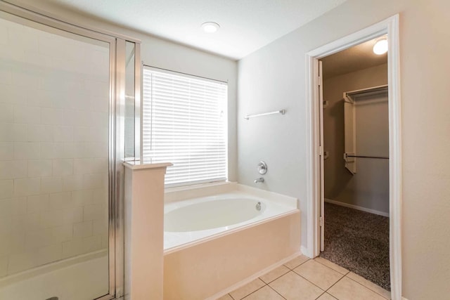 bathroom with tile patterned flooring and independent shower and bath