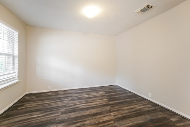 spare room with dark hardwood / wood-style flooring