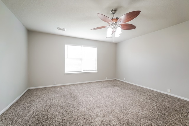 spare room featuring carpet and ceiling fan