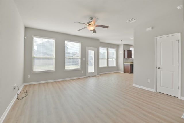 unfurnished living room with ceiling fan and light hardwood / wood-style floors