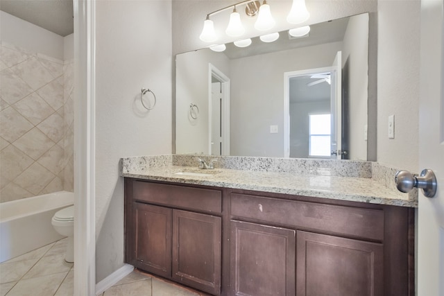 full bathroom featuring ceiling fan, tile patterned flooring, toilet, vanity, and tiled shower / bath