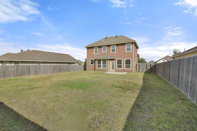 rear view of property with a yard and a patio