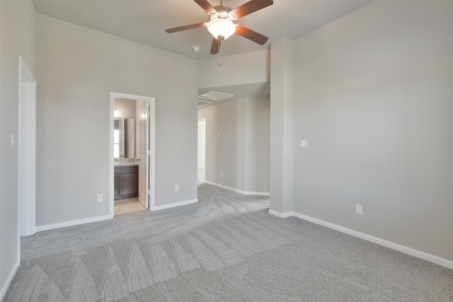 unfurnished bedroom with light carpet, ensuite bath, and ceiling fan