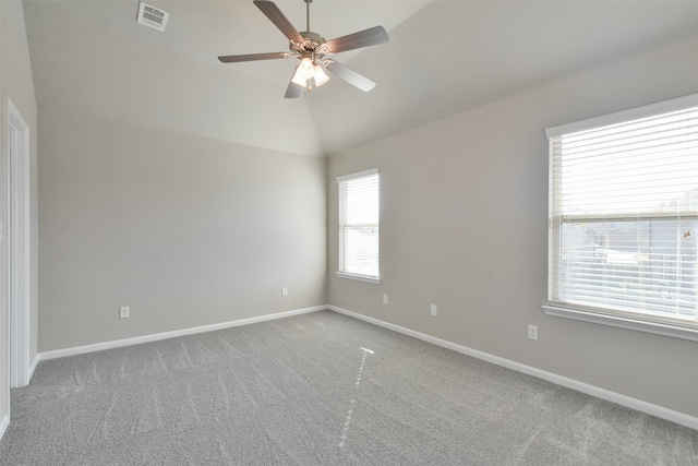 spare room featuring carpet flooring, ceiling fan, and vaulted ceiling